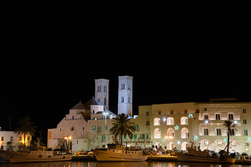 Molfetta, Italy, night view of the old harbour with the romanesque cathedral.