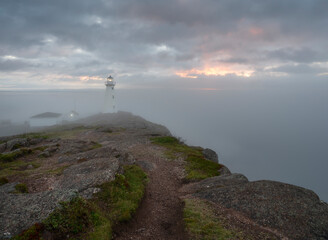 Fototapeta na wymiar Fog over the lighthouse at Cape Spear