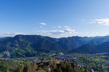 View from rock to town of Smolyan with meadows for cattle walking and houses between mountain range of Rhodope Mountains