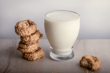 Glass of milk with cookies by the side