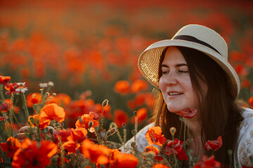 Scenic picturesque of beautiful girl in white and beige dress and straw hat in poppy field at sunset, Portrait of romantic young woman with flowers, body positivity, Selective focus natural light