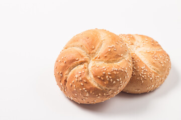 Fresh bread with seeds on a white table background. Bakery. Food security concept. 