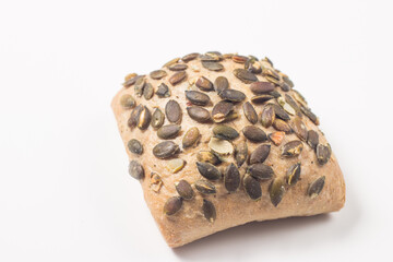 Fresh bread with seeds on a white table background. Bakery. Food security concept. 