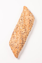 Fresh bread with seeds on a white table background. Bakery. Food security concept. 