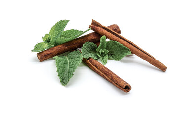cinnamon sticks garnished with peppermint leaves on white background