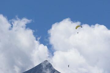 paragliding over clouds in bavaria, germany