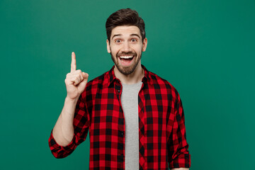 Young happy insighted smart proactive man he 20s in red shirt grey t-shirt holding index finger up...