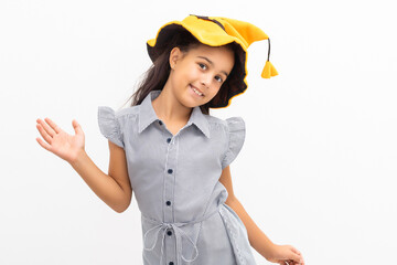 little girl in a witch hat on a white background