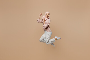 Full size young arabian asian muslim woman she in abaya hijab pink clothes jump high do winner...