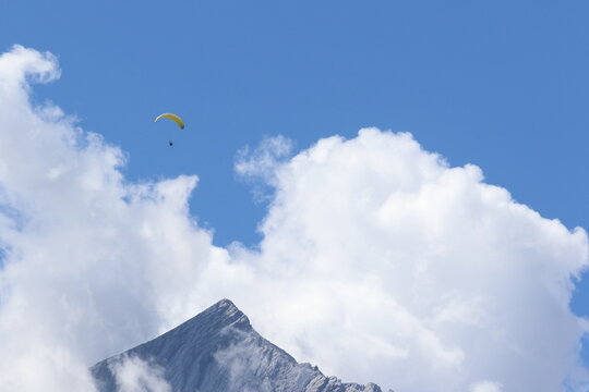 paragliding over clouds in bavaria, germany