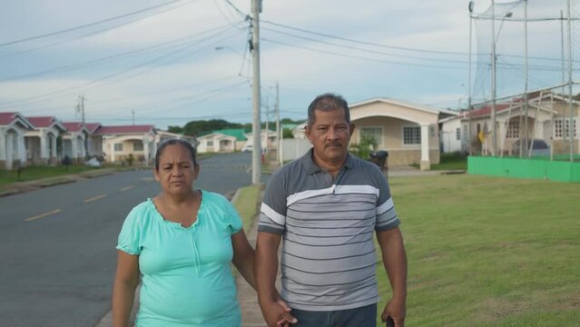 adult couple walking head-on, Latino family