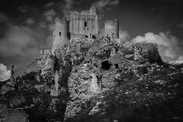 Black and white view of castle ruins on mountain top at Rocca Calascio, italian travel destination,...
