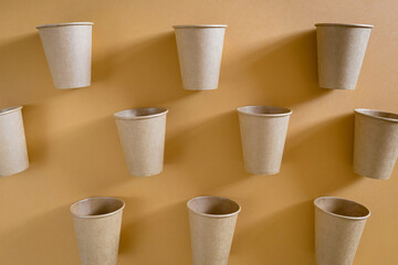Eco friendly craft paper cups on pastel background. Recycling concept.