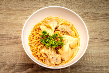 Egg noodles with pork wonton soup or pork dumplings soup and vegetable. Asian food style