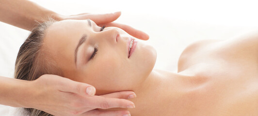 Young, beautiful and healthy woman in spa salon. Traditional massage therapy and skin care treatments.