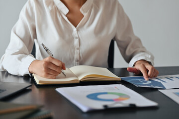 Close up with Asian businesswoman working with papers document, Business and Financial concept.