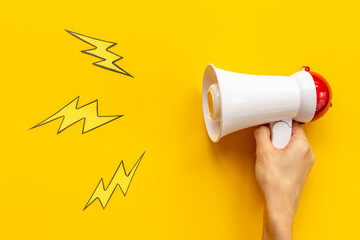 Attention concept. Hand holding megaphone for announcing hot news or advertising