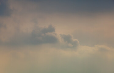dramatic color of sky at sunset, cottony clouds green, orange, gray gradient color change