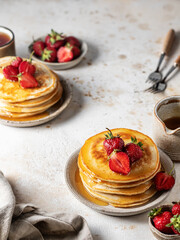 Delicious pancakes with strawberry on textured background. Breakfast for two composition rustic style
