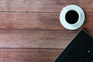 Top view of coffee cup and laptop with customizable space for ideas or text. Copy space.