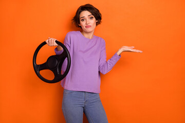 Photo of doubtful unsure girl dressed purple pullover riding auto shrugging shoulders isolated...