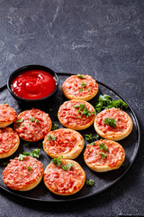 mini pizzas with ham and pecorino cheese, top view
