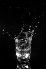 Water splashed into a glass of ice.