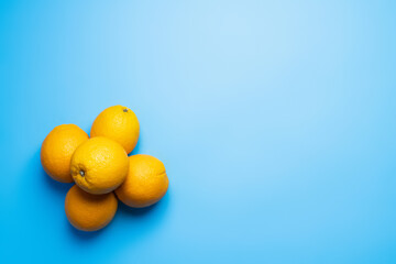 Top view of sweet oranges on blue background.