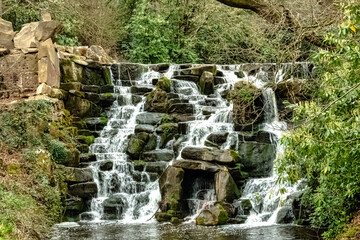 Fototapeta na wymiar Ornamental cascade waterfall in Virginia Water, Surrey, United Kingdom