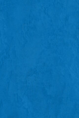 Saturated turquoise blue colored low contrast Concrete textured background. Empty colourful wall texture with copy space for text overlay and mockups. 2023, 2024 color trend
