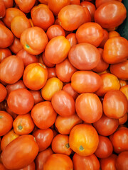 Red tomatoes on shelf supermarket, summer tray market agriculture farm full of organic vegetables.