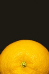 Close up view of orange in peel isolated on black.