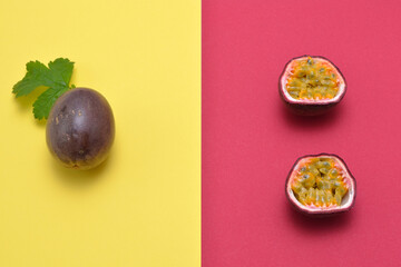 whole and cut passion fruit on a bicolor background