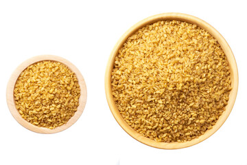 Raw bulgur in a wooden bowl isolated on white background top view.