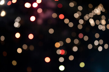 On a black background bokeh from explosions of colorful fireworks.