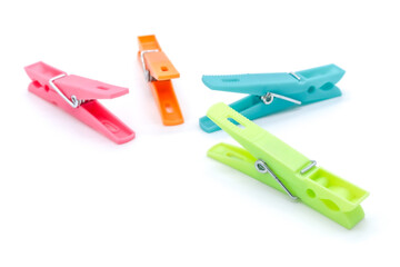 plastic clothespins of different colors on white background