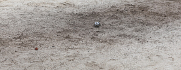 petanque, game with steel balls on the sand