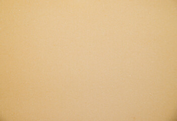 Abstract background made of foam sponge of light yellow color. Uneven surface.Texture.