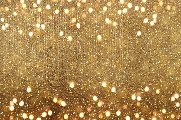 Gold bokeh. The effect of and blurring shiny balls. Defocused holiday lights. Glitter. Abstraction.