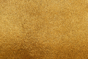 Fototapeta premium The texture of small gold chips or glitter.