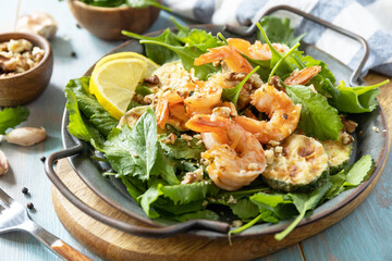 Healthy food concept. Diet summer salad plate. Shrimps salad with arugula, grilled zucchini and walnut.