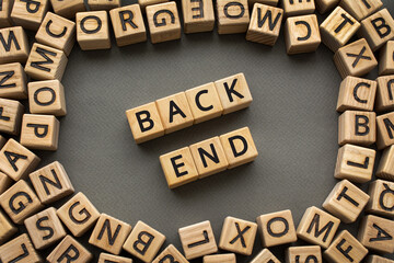 Inscription BackEnd software development concept. Wooden cubes with letters scattered blurred background