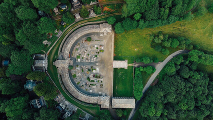 Aerial high angle view of The Monumental Cemetery of Oropa, graveyard built for noble families of the Biellese territory in Northern Italy. Semicircular architecture plan.