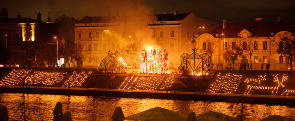 Autumn Equinox, marking the beginning of the astronomical autumn is celebrated in Vilnius by burning wooden sculptures on the Neris embankment near the King Mindaugas Bridge. - obrazy, fototapety, plakaty