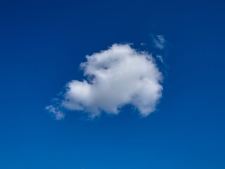 Fototapeta na wymiar One fluffy cloud in the blue sky