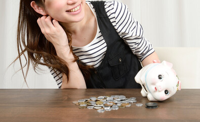 貯金箱を開けて笑顔の女性