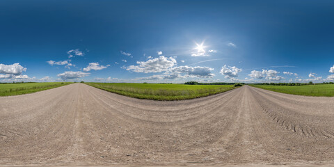 360 hdri panorama on no traffic gravel dusty road among fields with fluffy clouds in full seamless...
