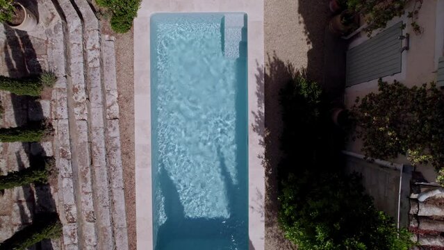 Swimming pool area and patio garden of rustic Mediterranean villa in southern France, Aerial looking down shot