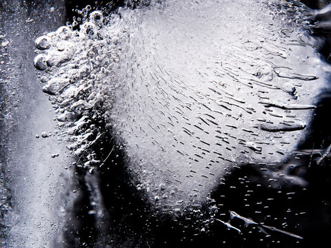 Texture of ice cube. Ice texture close-up background. Ice block on dark background.