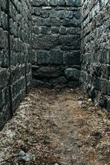 Vertical shot of a gray stone dead end path
